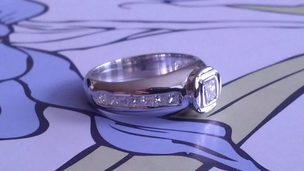 HALF ETERNITY WITH BEZEL SET CENTRE DIAMOND AND CHANNEL SET SIDES ENGAGEMENT RING